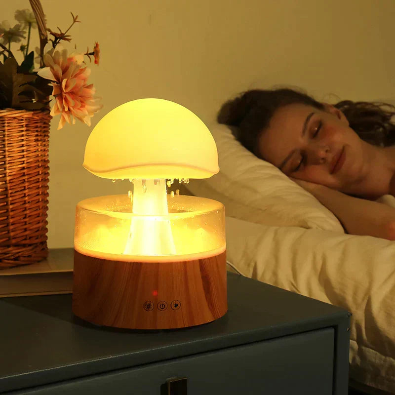 Mushroom cloud rain humidifier in wood finish on a bedside table with sleeping woman