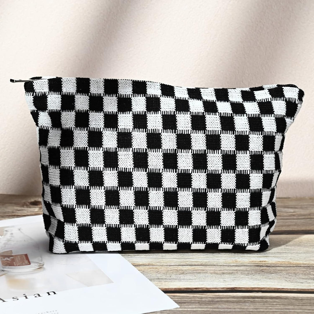 Front view of the stylish black and white checkered cosmetic pouch