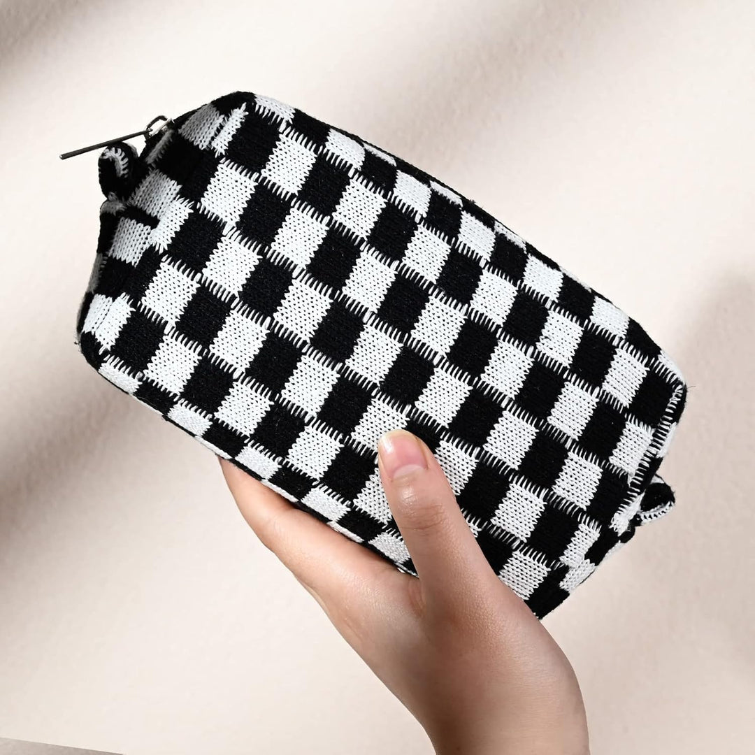 Hand holding the compact and spacious checkered travel organizer