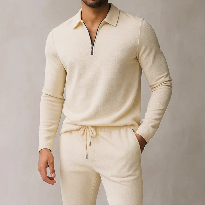 Man wearing a beige quarter zip polo tracksuit set