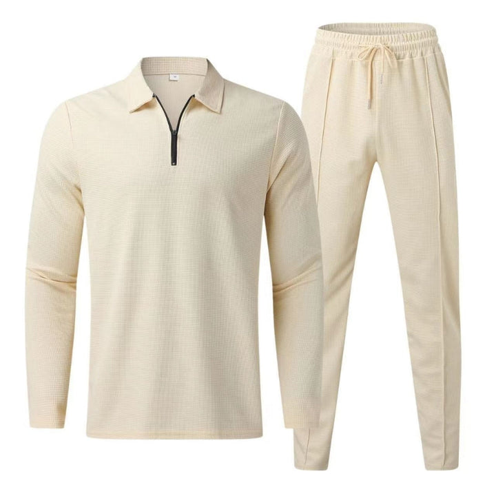 Flat lay of beige long sleeve polo top and matching jogger pants