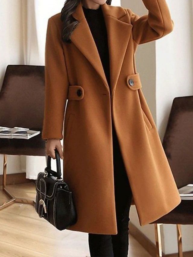 Back view of classic womens belted long coat featuring elegant slit and sleek winter coat silhouette
