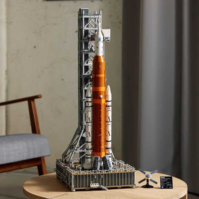 Fully assembled NASA Artemis rocket model displayed on a wooden table in a living room setting.