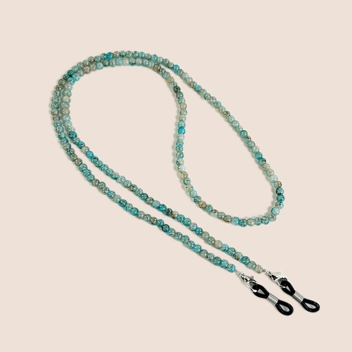 Women's beaded eyewear chain close-up showing colorful seed beads and secure eyeglass loops