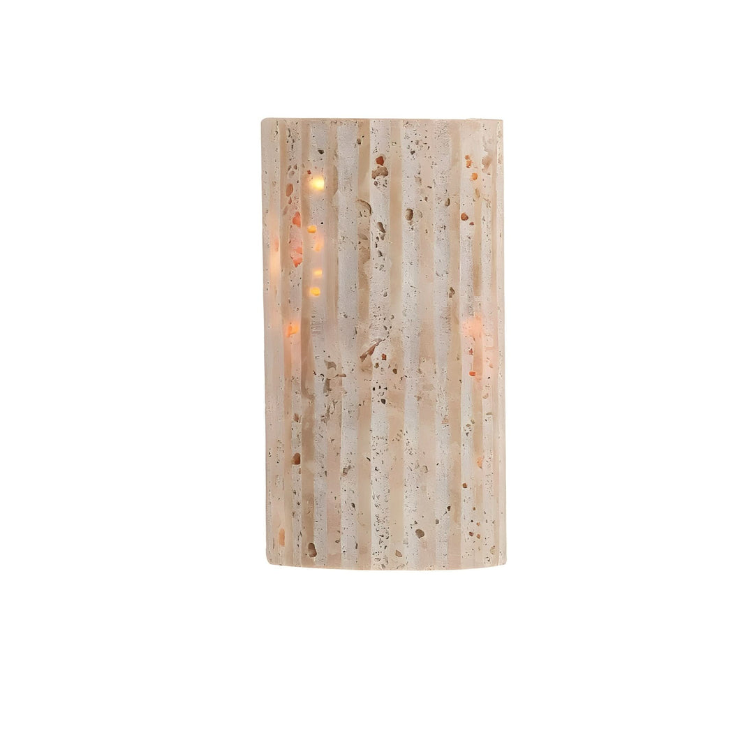 Stylish stone wall sconce casting a soft glow, perfect for modern interior home lighting.