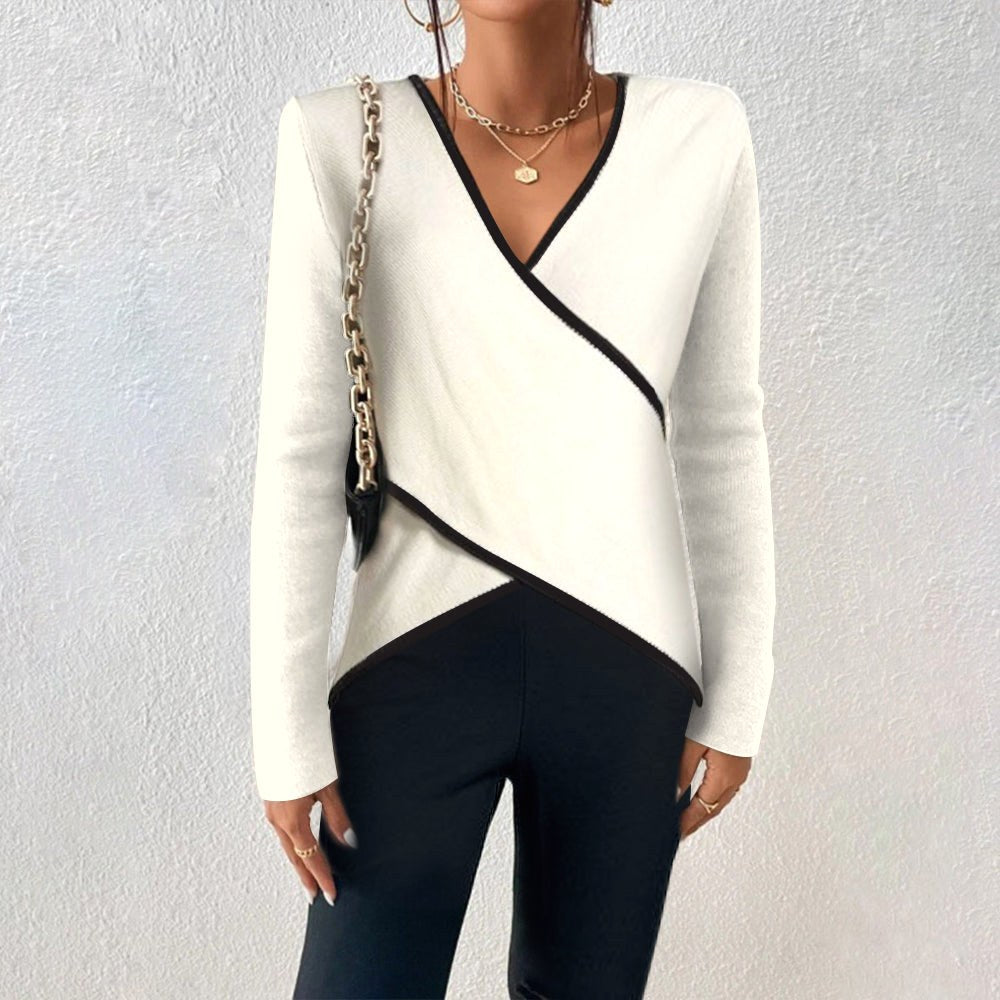Women wearing a white V-neck pullover sweater with dark trousers
