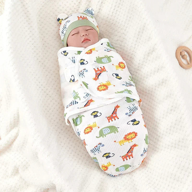 Newborn baby sleeping peacefully wrapped in a Zoo pattern swaddle with matching hat