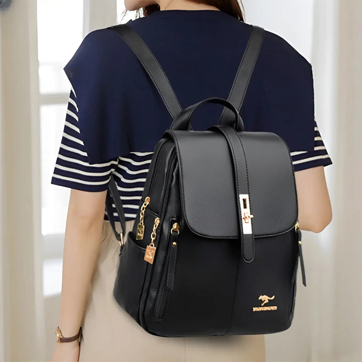 Woman wearing the black Alena backpack showing rear straps and side profile