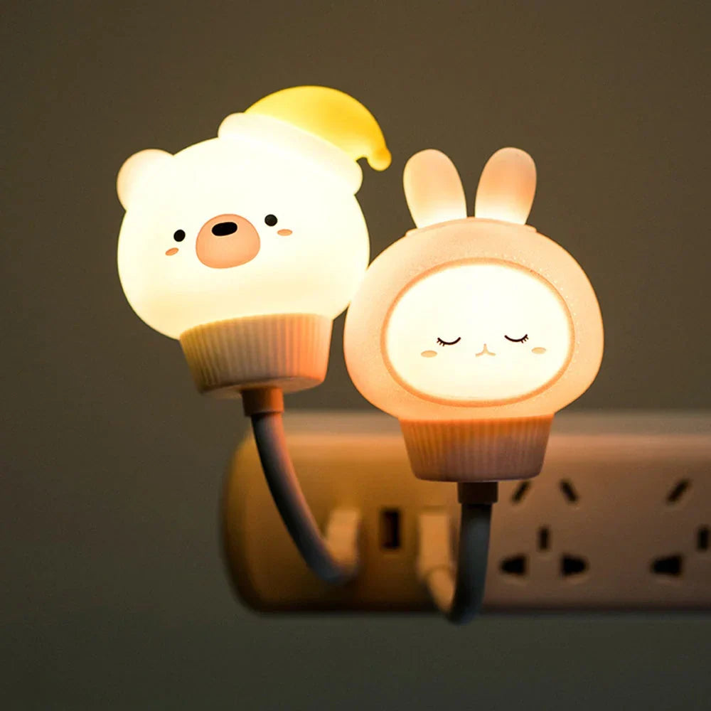 Cute glowing bear and bunny USB night lights plugged into a wall outlet