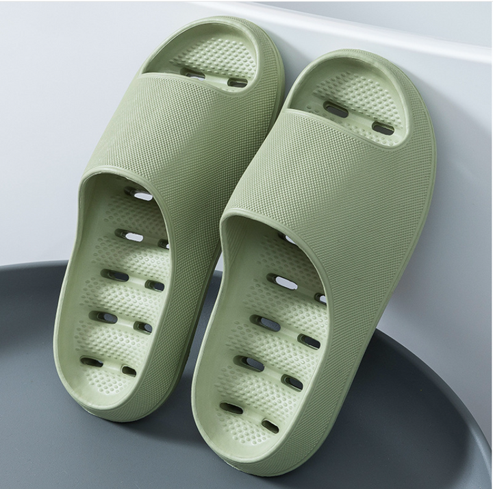 Green non-slip bathroom slippers showcased upright