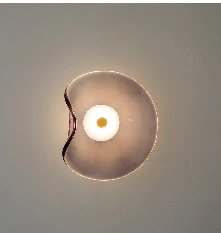 Close-up view of the Nordic glass wall lamp lit up in light purple shade
