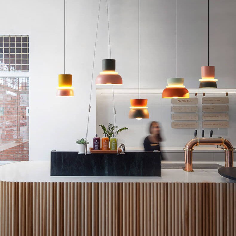 Nordic hanging lamps installed above a modern cafe counter, showcasing stylish kitchen pendant lighting.