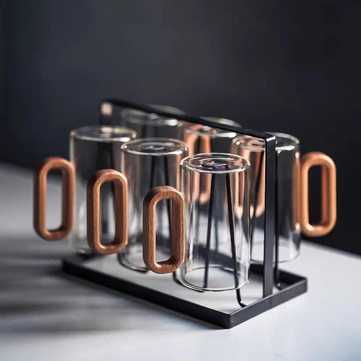 Set of glass mugs with wooden handles in a metal rack