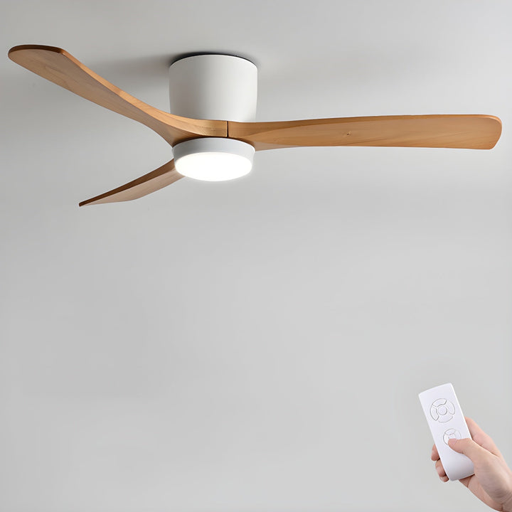 Ceiling fan with remote control resting on a minimalist wooden surface