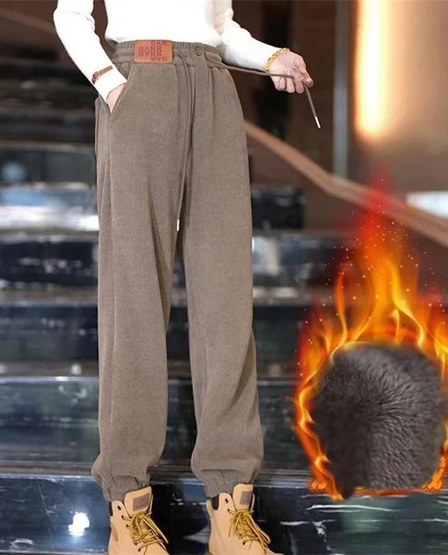 Woman wearing brown extra warm fleece-lined winter joggers with boots
