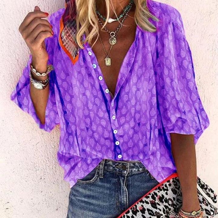 Woman wearing stylish purple button-front blouse with three-quarter sleeves