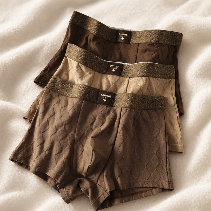 Folded men's boxer briefs in dark earth tones showcasing textured diamond weave