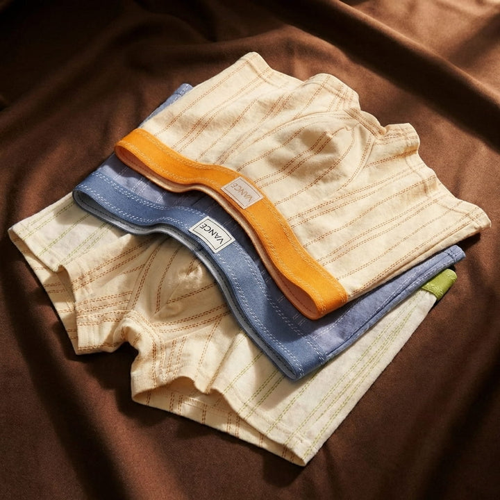 Assorted colorful men's boxer briefs folded and stacked together.