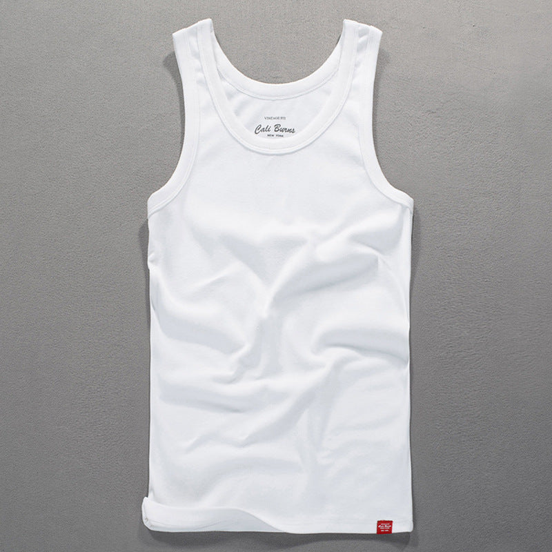 White men's tank top laid flat on a grey textured surface