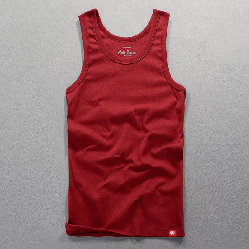 Red men's tank top laid flat highlighting the fabric texture and color