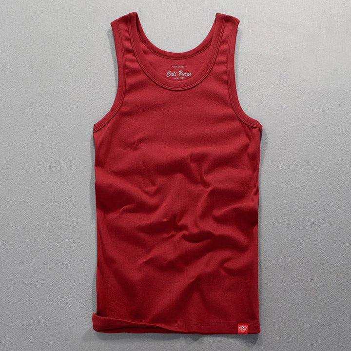 Red men's tank top laid flat highlighting the fabric texture and color