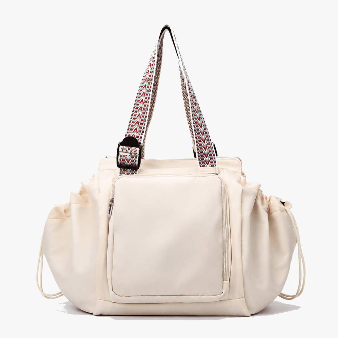 Beige convertible everyday tote and backpack featuring drawstring side pockets