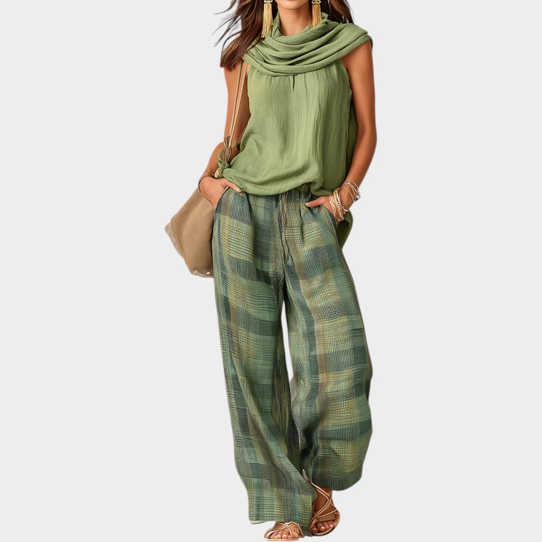 Front view of woman wearing a green scarf-neck top and patterned wide-leg pants matching set
