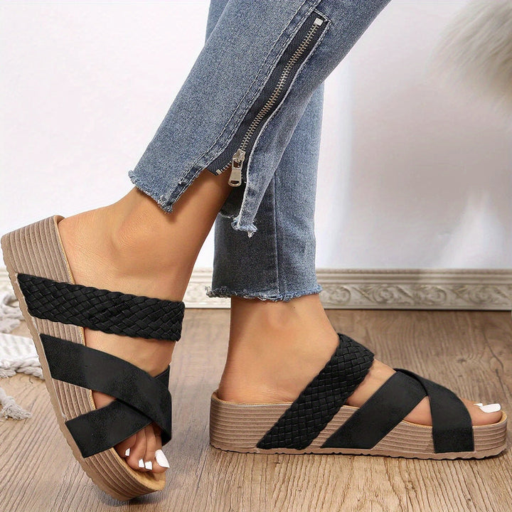 Black women's orthopedic woven platform sandal worn with jeans