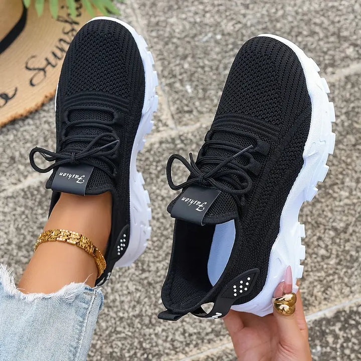 Black women's orthopedic walking sneaker with mesh upper and thick white sole