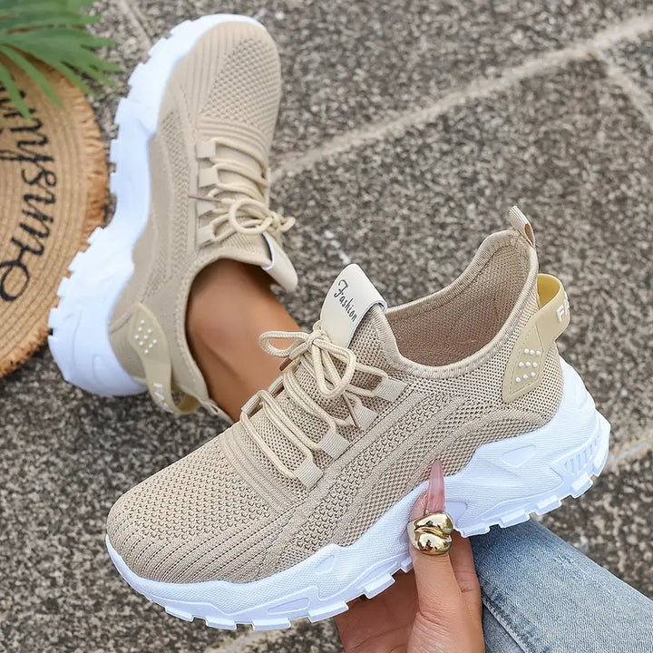 Beige women's supportive lifestyle sneaker with lace-up closure and textured sole