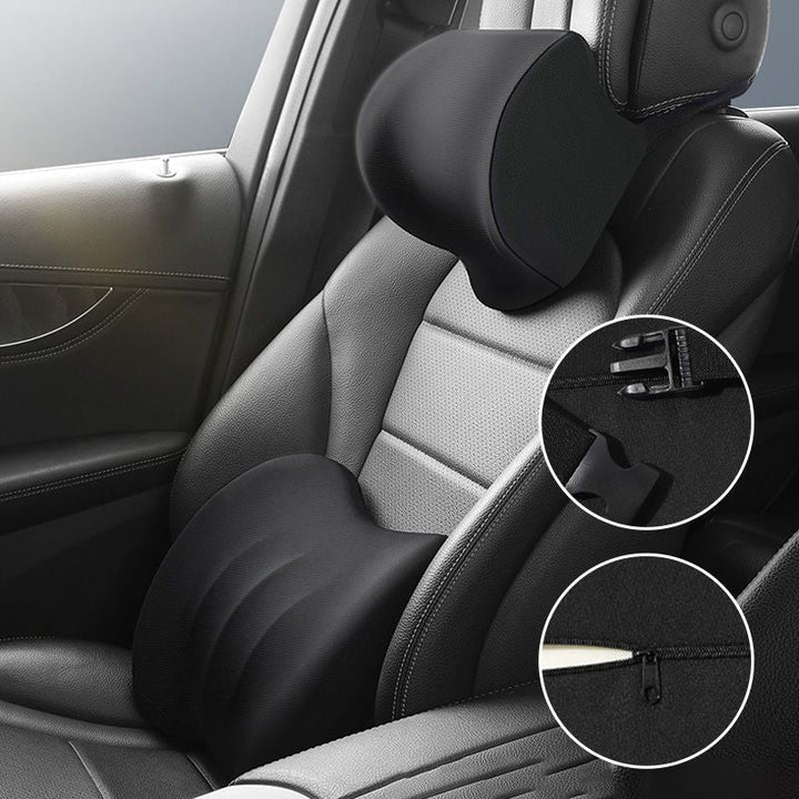 Black orthopedic car pillow mounted on a vehicle seat showing buckle and zipper details