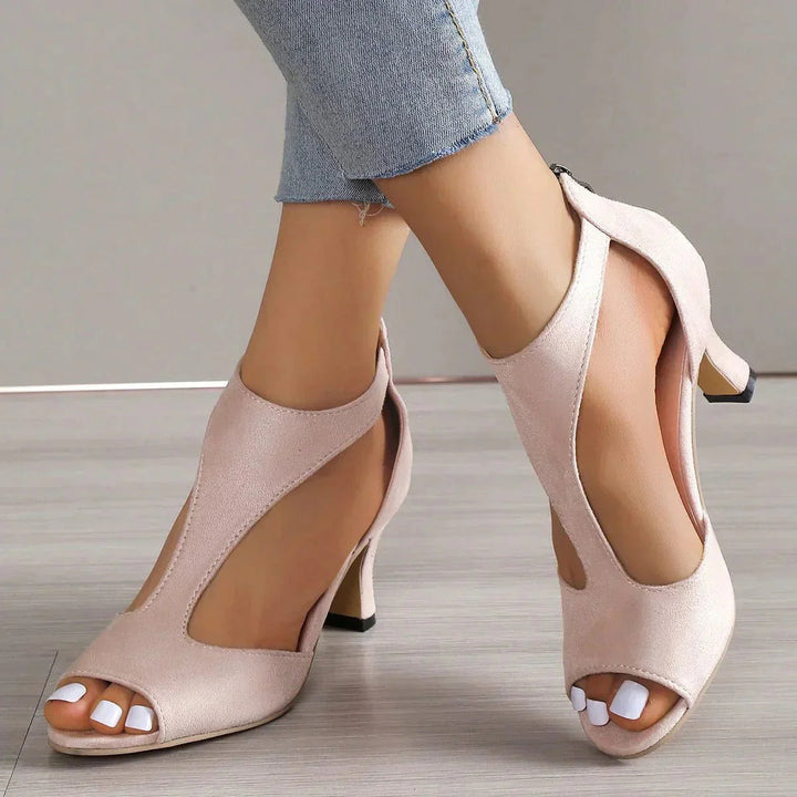 Model wearing light pink orthopedic t-strap block heels with open toe design