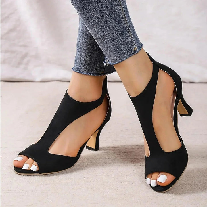 Model wearing black orthopedic t-strap block heels paired with jeans