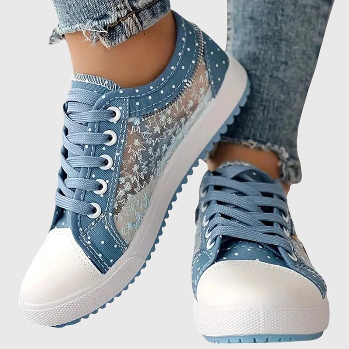 Front view of blue orthopedic sneakers with breathable mesh panels and white toe caps