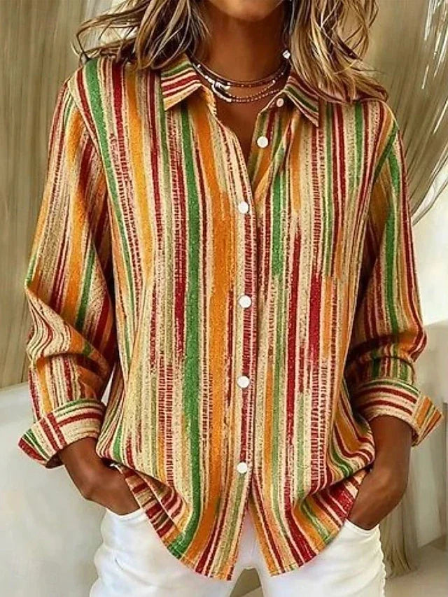 Woman wearing orange palette striped button blouse with white pants