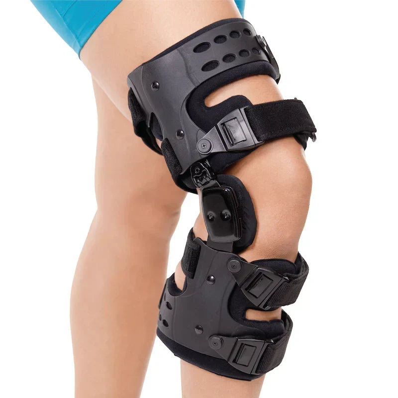 Close-up of the right knee brace worn on a user's leg, showcasing the outer shell and dual straps