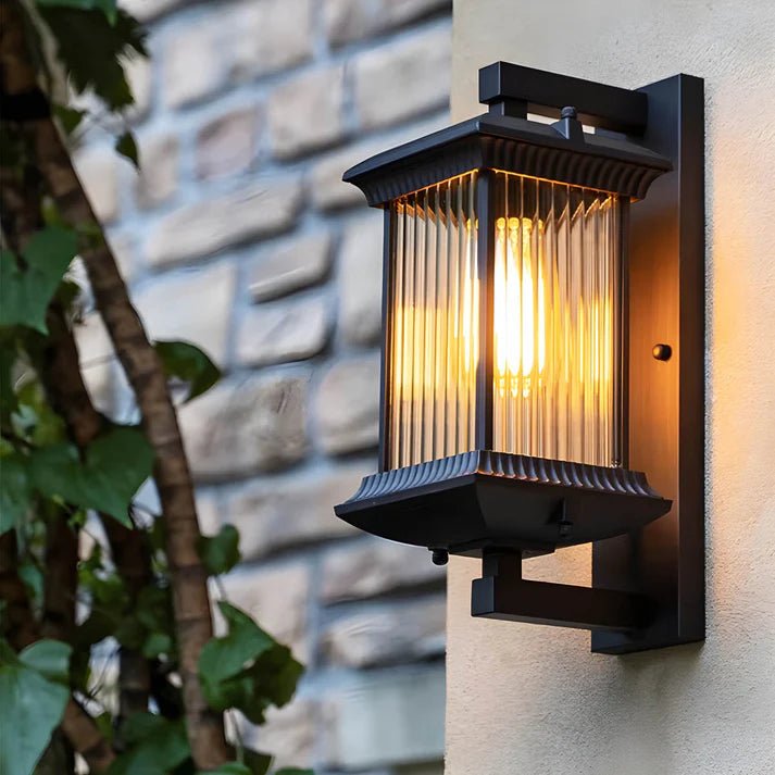 Outdoor wall lamp mounted on a stone wall with warm illumination