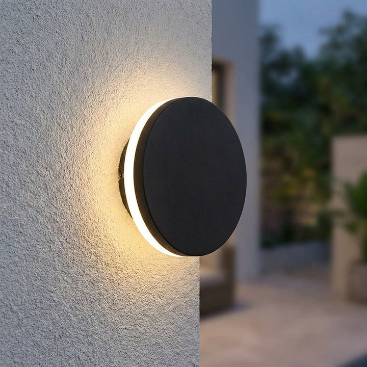 Outdoor wall lamp mounted on textured exterior wall with warm illumination