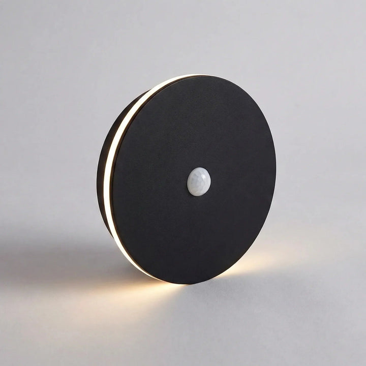 Outdoor wall lamp illuminating a dark entryway with warm LED up and down lighting.