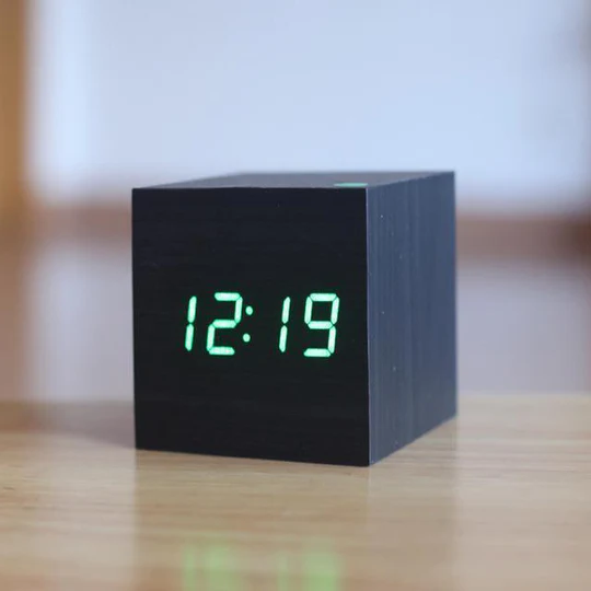 Black wooden digital alarm clock with bright green LED display