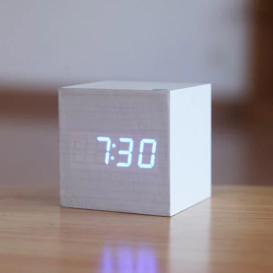 White wooden minimalist digital cube clock with glowing blue numbers