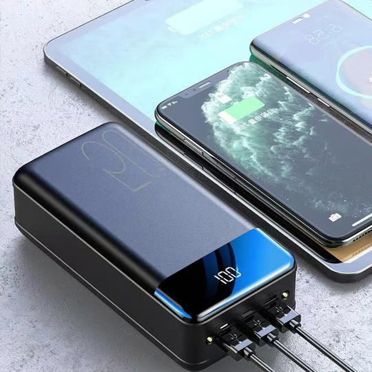 Portable power bank charging multiple smartphones and a tablet simultaneously