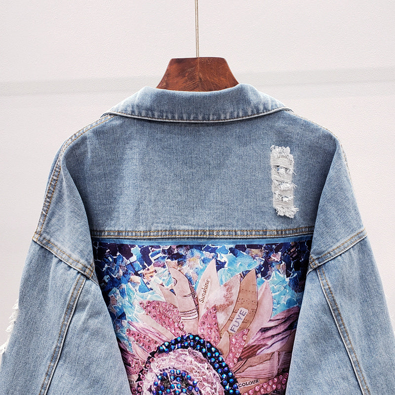 Close-up of the artistic back print detail on the denim jacket