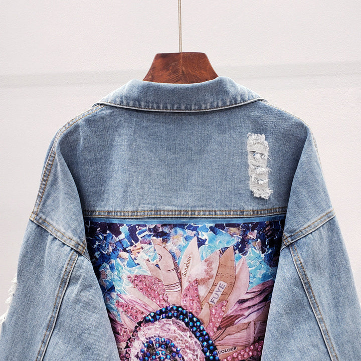 Close-up of the artistic back print detail on the denim jacket