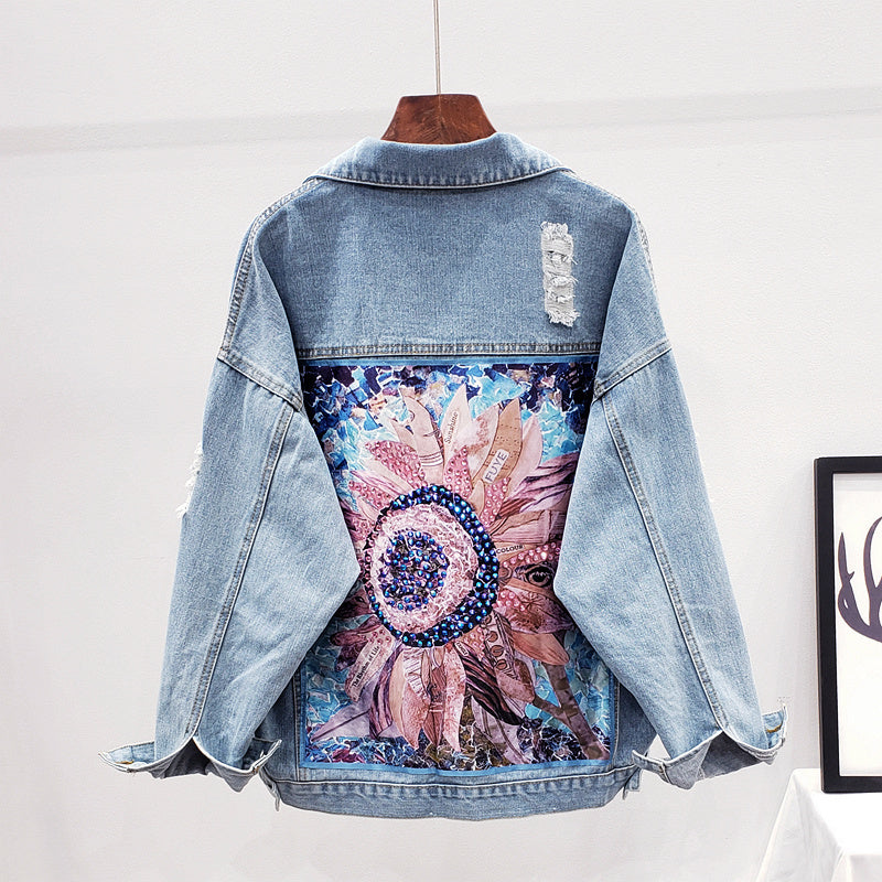 Back view of women's oversized denim jacket with floral graphic print