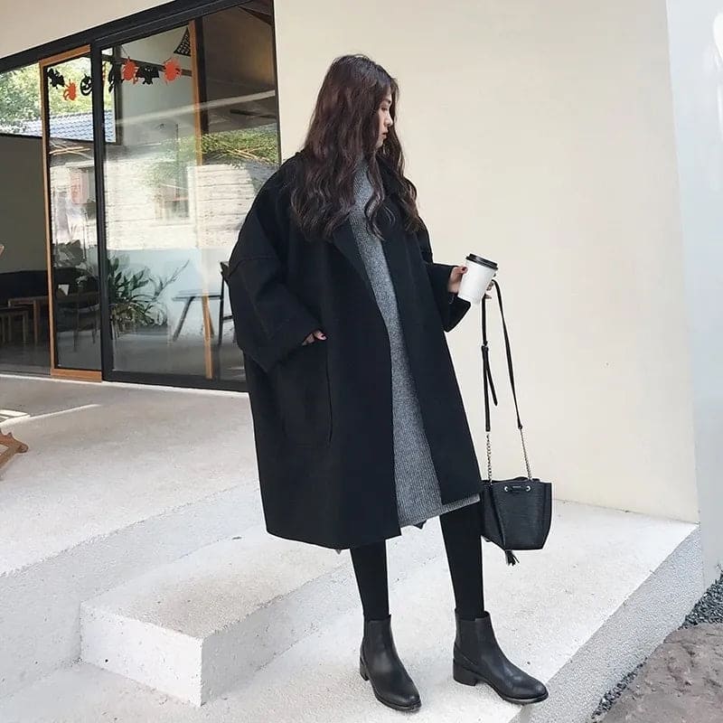 Oversized wool blend trench coat in coffee color, featuring wide lapels and button front.