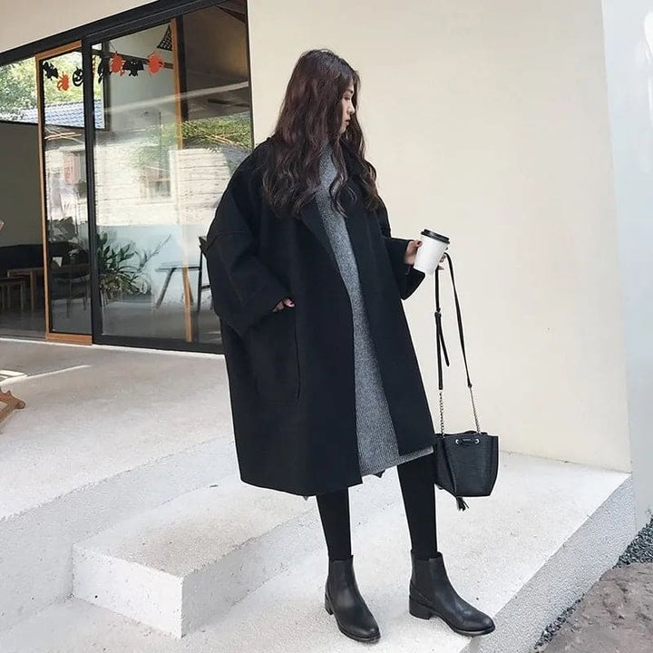 Oversized wool blend trench coat in coffee color, featuring wide lapels and button front.