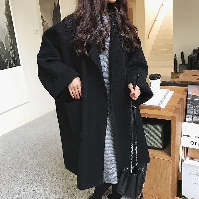 Womens winter fashion black coat with a relaxed oversized fit and longline silhouette.