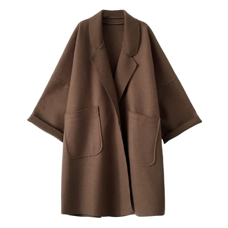 Back view of the oversized coffee trench coat showing the classic tailored drape.