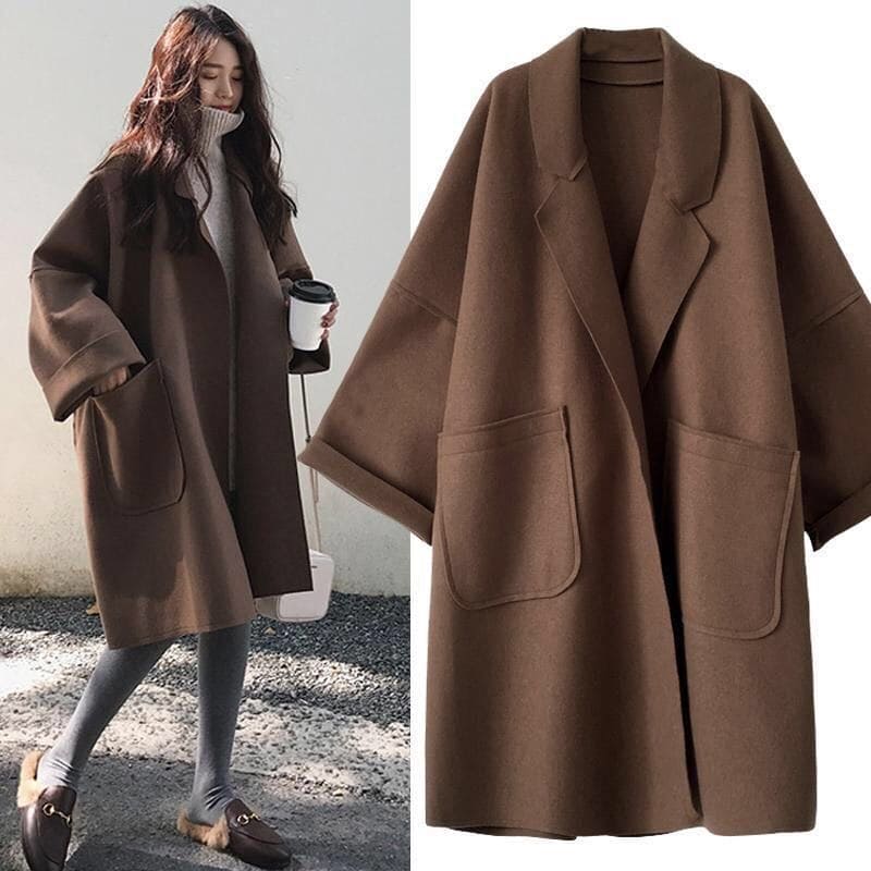 Model wearing the Aura oversized trench coat in coffee colour with matching handbag